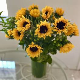 Bouquet of yellow sunflowers in a green vase