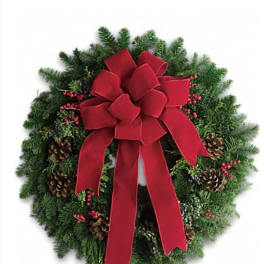 Christmas wreath with a red bow, pinecones, and red berries