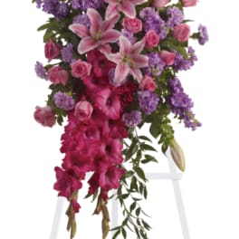 Tall pink and purple floral spray on a white easel