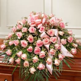 Large pink rose casket spray with ribbon accents