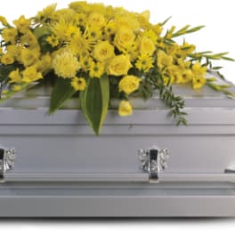 Yellow floral spray on a silver casket