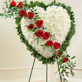 Heart-shaped standing spray of white flowers with red roses