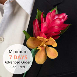 Red tropical flower and golden orchid boutonniere on a black suit lapel