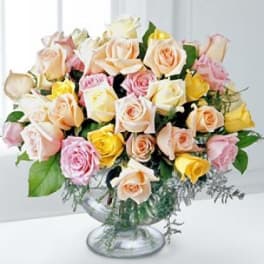 Bouquet of pastel roses in a clear glass vase