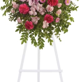 Pink and red floral spray on a white easel
