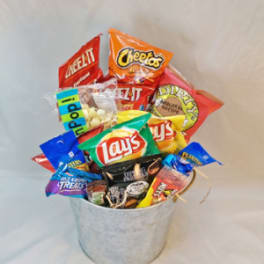 Bucket filled with assorted snack bags and popcorn packages