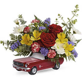 Flower arrangement in a red pickup truck container