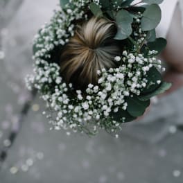 Floral crown with white baby's breath and eucalyptus on a person's hair