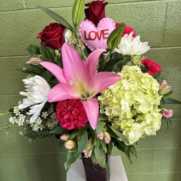 Pink lily and red rose arrangement with a heart-shaped LOVE pick