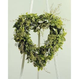 Heart-shaped greenery wreath on a stand