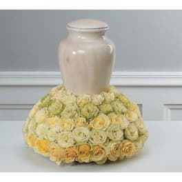 Cream urn with a collar of pale yellow roses