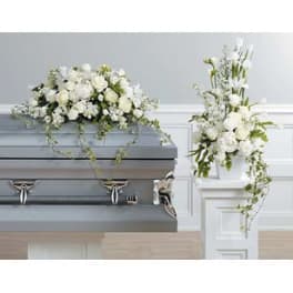 White floral casket spray and matching standing arrangement