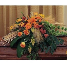 Orange and yellow floral arrangement with roses and lilies