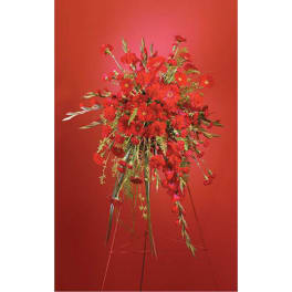 Tall red floral arrangement on a stand against a red background