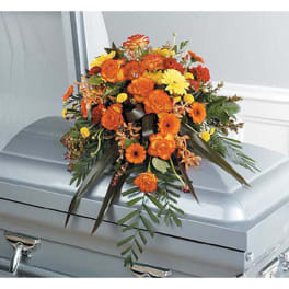 Orange and yellow floral spray on a silver casket