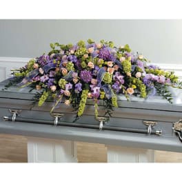 Large pastel floral spray on a gray casket