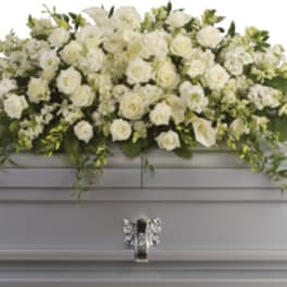 White floral casket spray with roses and calla lilies