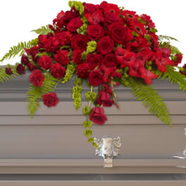 Red rose and carnation casket spray with fern accents