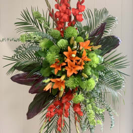 Tall tropical floral arrangement with orange lilies and red gladiolus