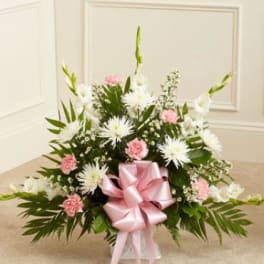 Pink and white floral spray with a pink ribbon bow