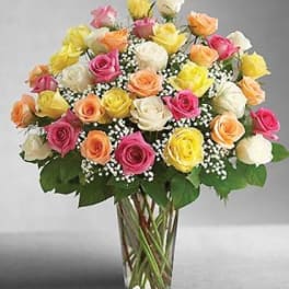 Bouquet of multicolored roses in a clear glass vase