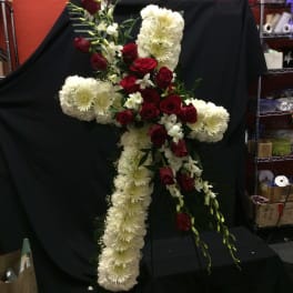 Cross-shaped floral spray with red roses and white chrysanthemums