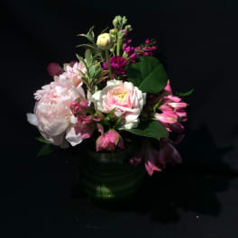 Pink and white mixed flower arrangement in a glass vase