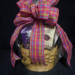 Gift basket with chocolates and brownies tied with a large plaid ribbon