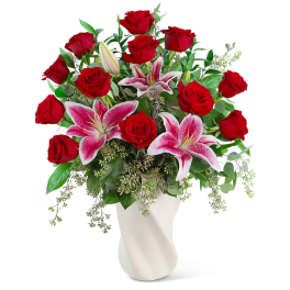 Bouquet of red roses and pink lilies in a white vase