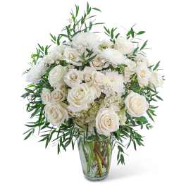 White roses and chrysanthemums in a clear glass vase