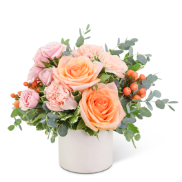 Pink and peach roses in a white vase