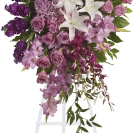 Tall purple and white floral spray on a white easel