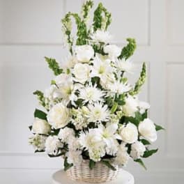 White floral arrangement in a wicker basket