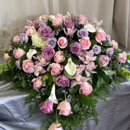 Large bouquet of pink and lavender roses with orchids and white calla lilies