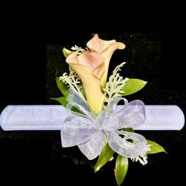 Calla lily corsage with a white ribbon bow