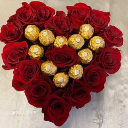 Heart-shaped bouquet of red roses with gold-wrapped chocolates