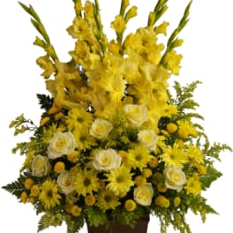 Yellow floral arrangement in a brown urn vase