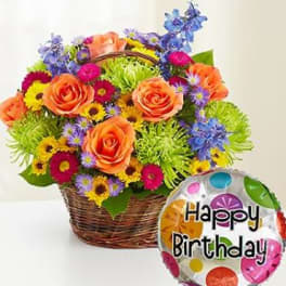 Basket of colorful flowers with a Happy Birthday balloon