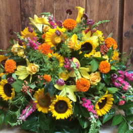 Large mixed bouquet with sunflowers, yellow lilies, and orange blooms