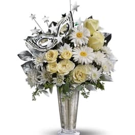 White roses and daisies in a tall silver vase with star picks