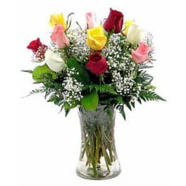 Bouquet of multicolored roses in a clear glass vase