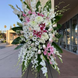 Large standing floral spray with white and pink flowers on an easel
