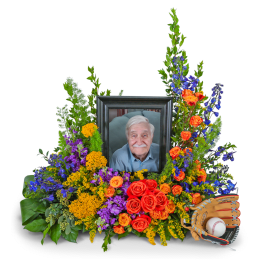 Floral tribute with a framed portrait and baseball glove and ball