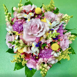 Round bouquet of pink roses, chrysanthemums, and mixed blooms
