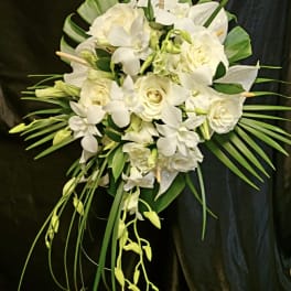 White floral bouquet with roses and orchids on a dark background