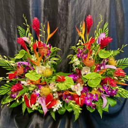 Tropical floral arrangement with red, orange, pink, and white blooms