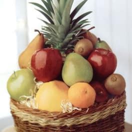 Fruit basket topped with a pineapple and assorted fruit