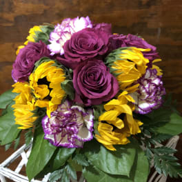 Bouquet of purple roses, yellow sunflowers, and white-purple carnations