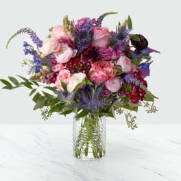 Mixed pink and purple bouquet in a clear glass vase
