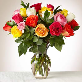Mixed roses in a clear glass vase